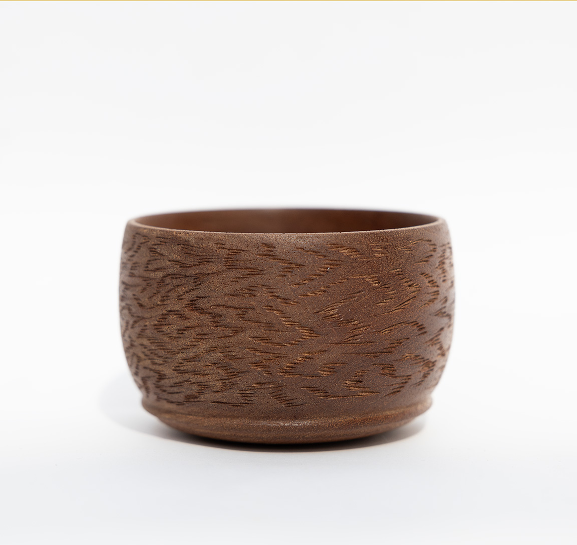 photograph of a bowl with carved patterns on the side
